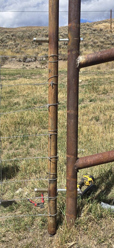 Photo 1. Holes are drilled and hinges are placed at the ends of each section of fence to allow the fence to pivot.